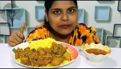 Eating chicken curry and yellow rice_ big bite